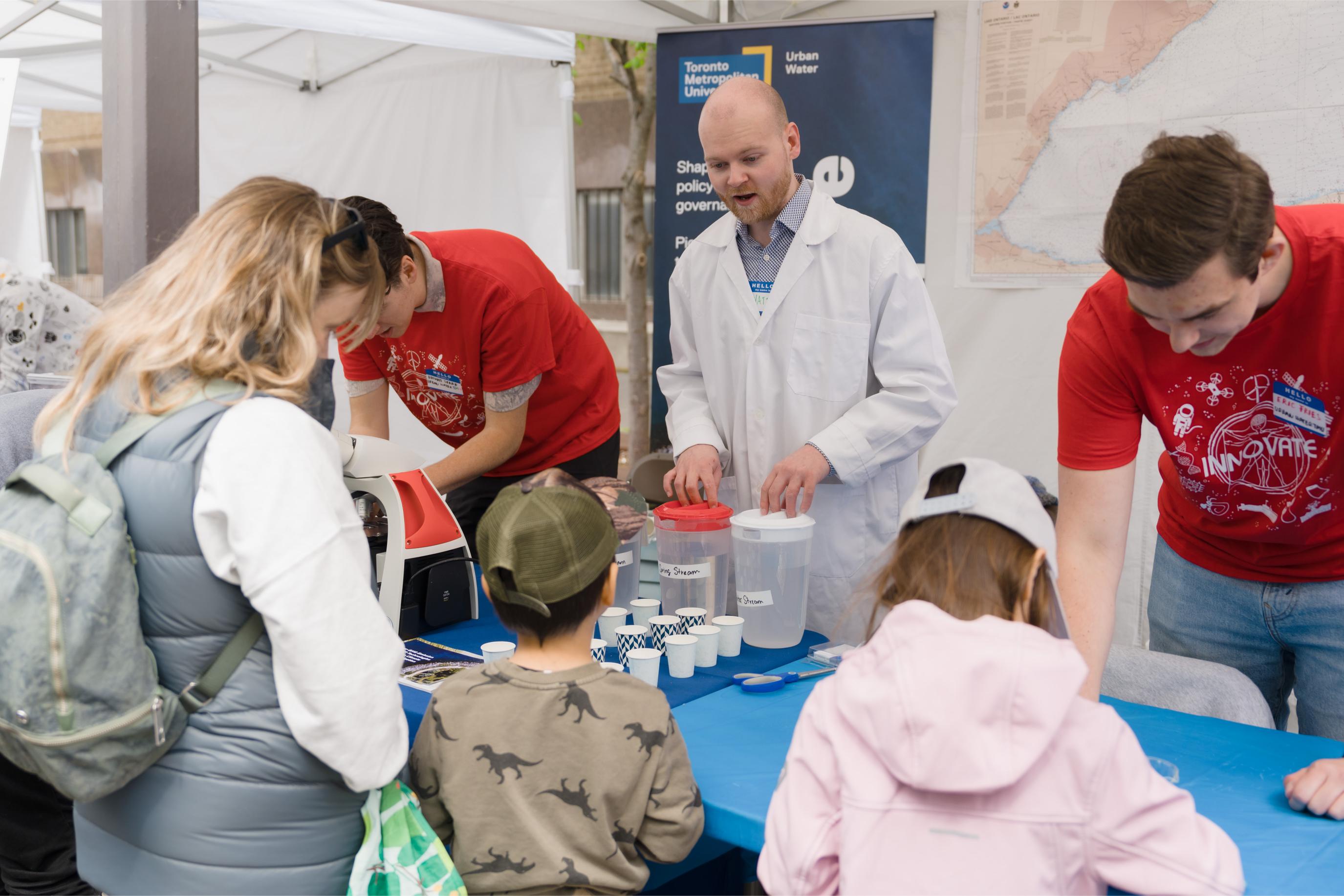 Volunteers interacting with participants at the Urban Water Booth.